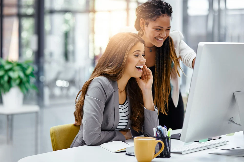 Two young women working in the office.